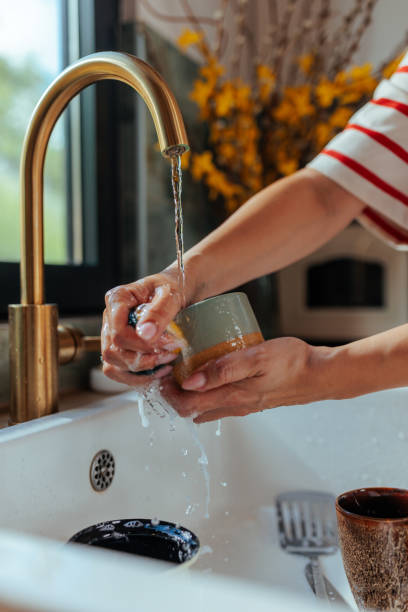 istock Close up of a woman's manicured hands washing a mug 2156107542