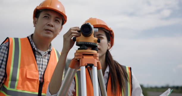 istock Senior construction male  engineer training a young new female  engineer and using a digital tablet with a hold walkie-talkie in his hand at the infrastructure of Sky bridge 2156109308