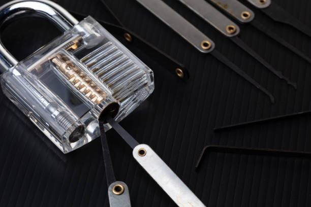 istock Clear Lock device over black background to show mechanic inside lock. Many lock pick tool to unlock key of door window vehicle for thief lockpick burglar. 2156109954