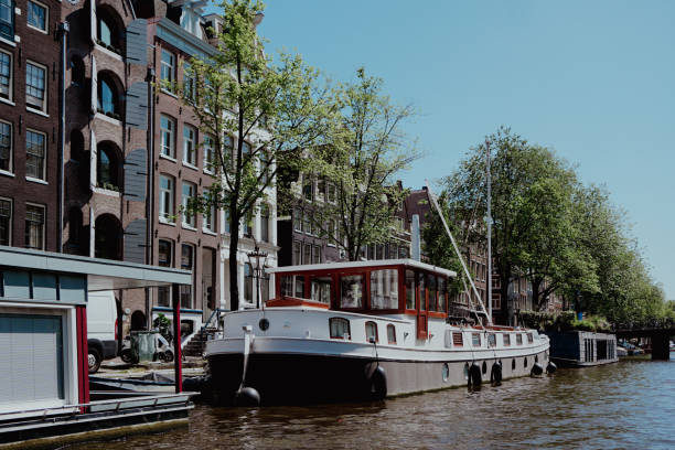 istock a boat docked on the side of a canal 2156110433