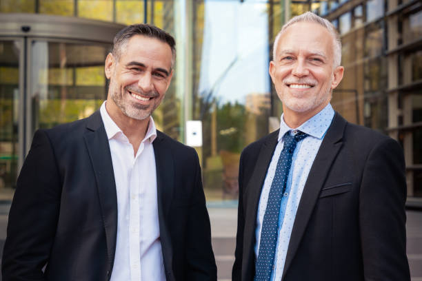 istock Portrait smiling two attractive and self-confident businessmen looking at camera 2156111725