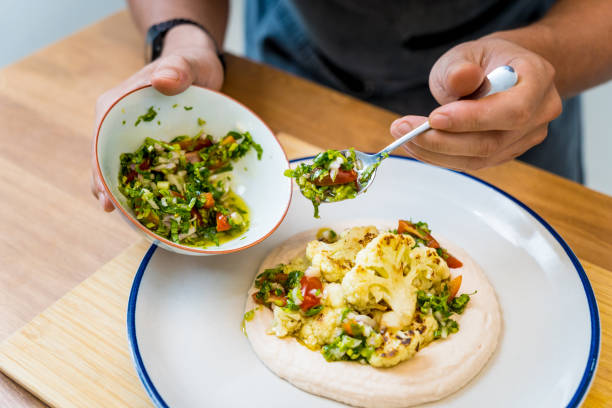 istock Chef at the kitchen preparing bean porridge with cauliflower and vegetables 2156112255