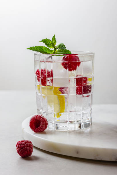 istock Raspberry cocktail with ice in a glass on a light background 2156115372