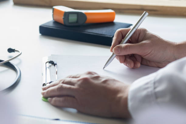 istock The doctor makes a note on a blank piece of paper. 2156120068