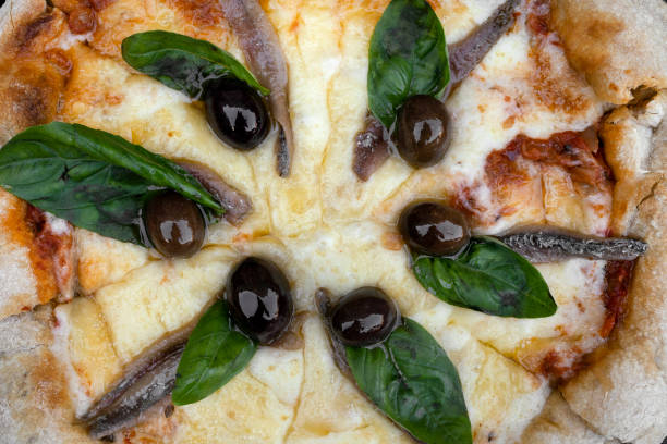 Extreme close-up of pizza with cheese and pelat isolated on a blue background