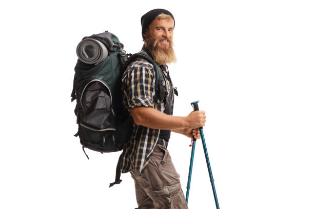 istock Bearded guy hiker with a backpack and hiking poles walking 2156120801