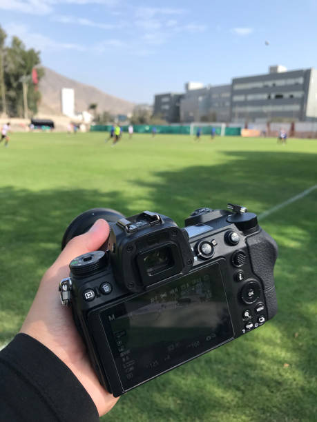istock Photographer capturing outdoor soccer game 2156125277