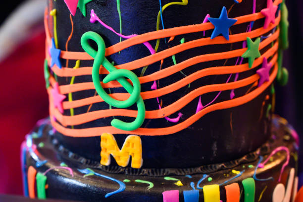 Close-up of a vibrant birthday cake decorated with musical notes and stars