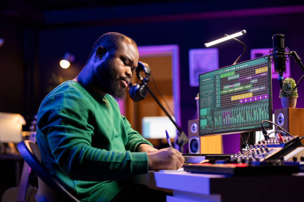 istock Composer writes verses and ideas to develop an original song in his home studio 2156127266