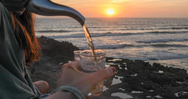 istock Friends enjoy tea at sunset on beach 2156128378