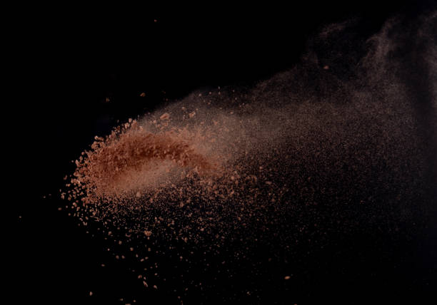 istock Brick Sand flying explosion,  Abstract cloud fly. Orange colored sand splash throwing in air on black background 2156129326