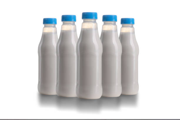 Plastic milk bottle with blue lid isolated on a white background.