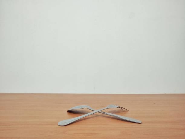 White dish spoon fork on wood background