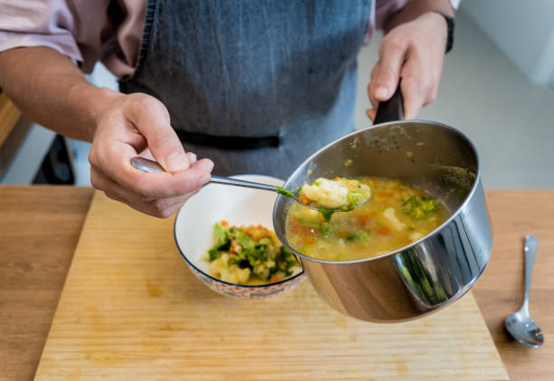 istock Chef at the kitchen preparing lentils soup with cauliflower and broccoli 2156131506