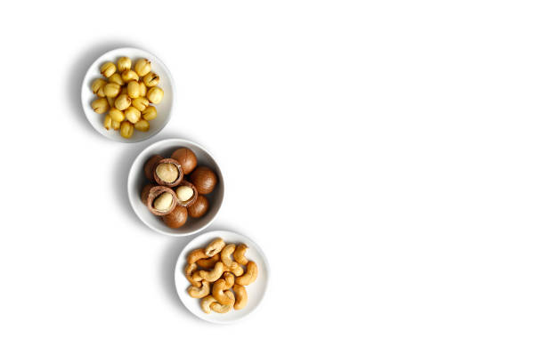Lotus seeds macadamia cashew snack food on white background. High angle view mixed bean nuts