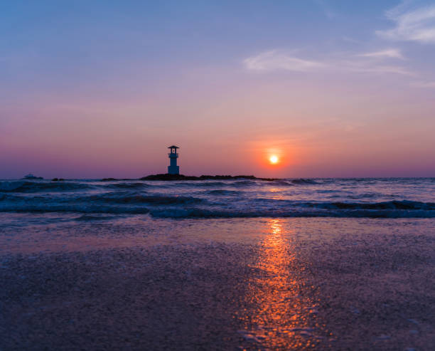 istock A lighthouse in the ocean during a beautiful sunset 2156134875