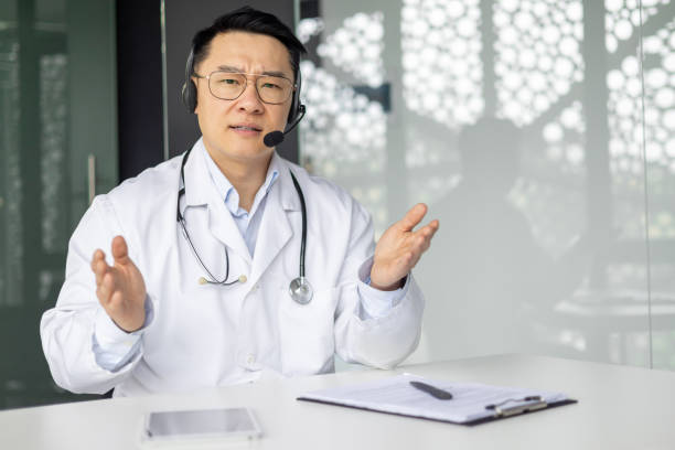 istock Asian doctor with headset giving online consultation 2156136265