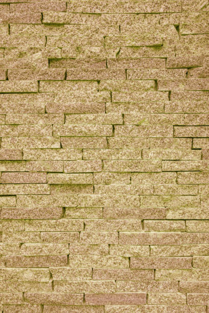 Yellow wall of rough brick. Abstract construction background.