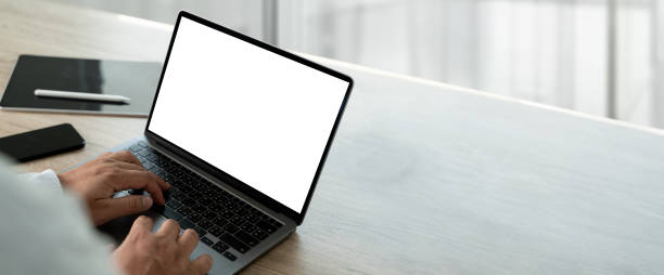 businessman using computer with empty blank screen in office marketing and design background for advertising text