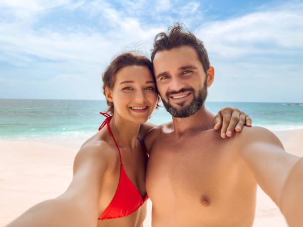 istock Happy Couple Taking Selfie on Tropical Beach Vacation 2156141663