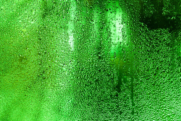 A dramatic close-up reveals the intricate texture and deep blue coloration of a surface covered with tiny water droplets and reflective elements