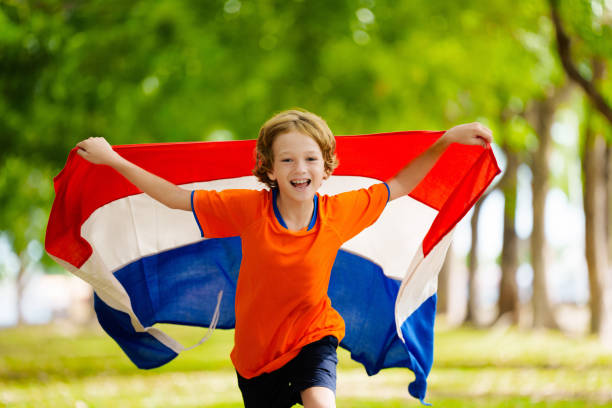 istock Netherlands team supporter. Dutch kid with flag. 2156145694