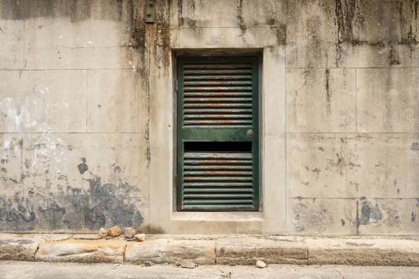 istock Old rusty broken door in a dirty concrete wall 2156146090