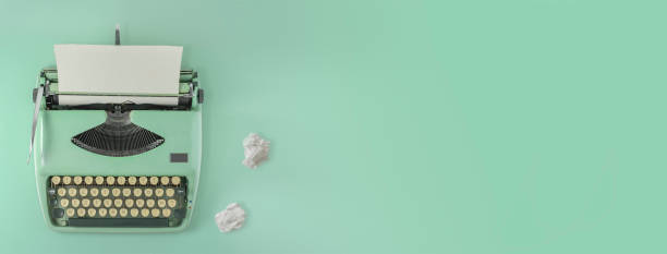 istock A green vintage typewriter with two paper balls. 2156147533
