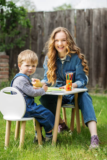 istock Mother and son drawing together outdoors. Early years. Baby development. 2156147631
