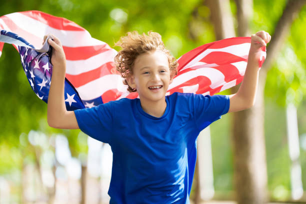 istock USA team supporter. American child with flag. 2156147837