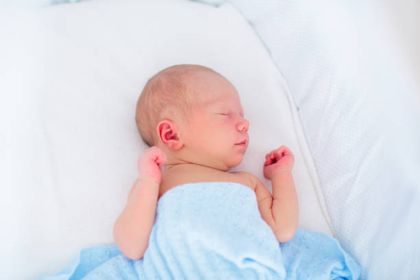 istock Little baby on white bed 2156148809