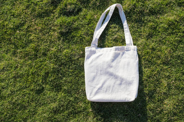 istock Mockup shopper handbag on green grass background 2156152143