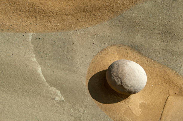 istock Texture of a round stone on sandstone on the seashore 2156152738