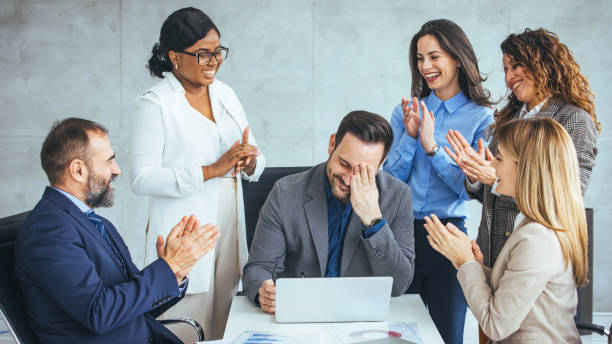 istock Diverse Team Applauding Excited Colleague in Office 2156153867