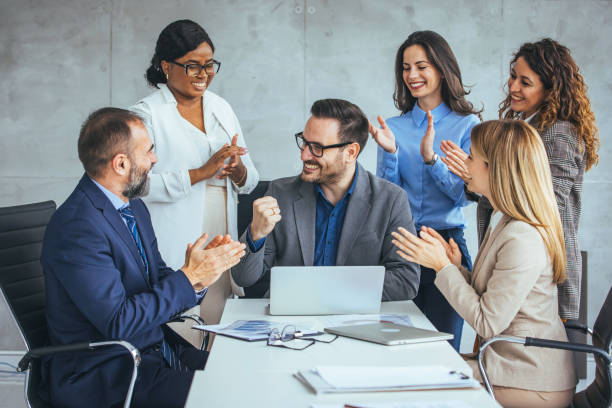 istock Multicultural Team Applauding Caucasian Colleague 2156153885