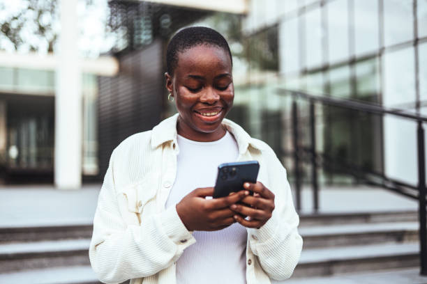 istock Black Female Student Enjoys Technology Break Outside University 2156154186