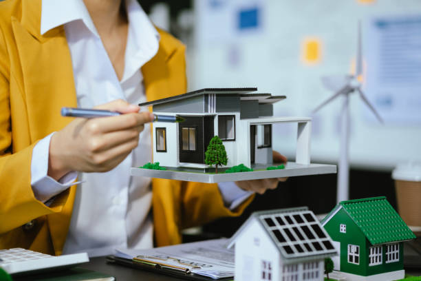 istock Architect working with blueprints for sketching a construction project, green energy and solar panel concept. 2156156825