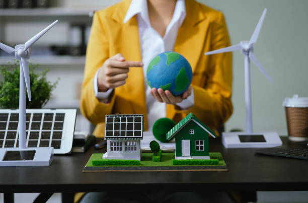 istock Architect working with blueprints for sketching a construction project, green energy and solar panel concept. 2156156836