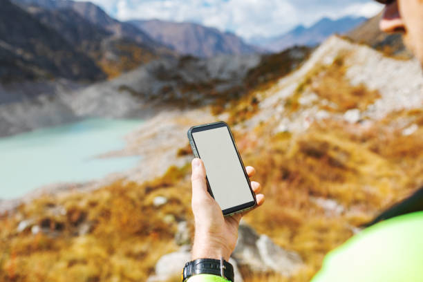 istock Mid adult man trekking in mountain using navigator 2156160099