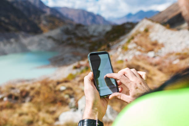 istock Mid adult man trekking in mountain using navigator 2156160141