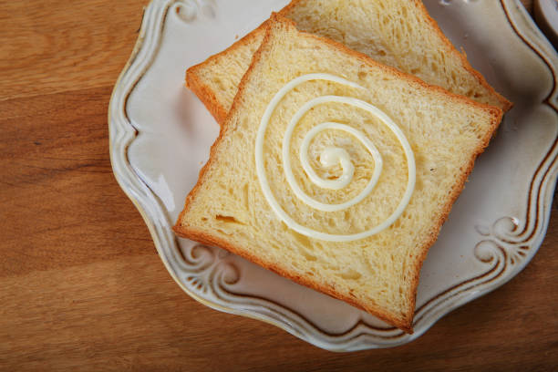 Grilled peanut butter and strawberry  jelly sandwich on a rustic background