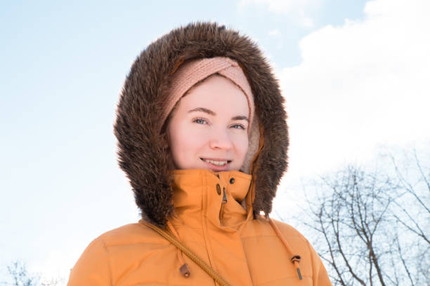 istock happy smiling woman face outdoors in winter 2156160305