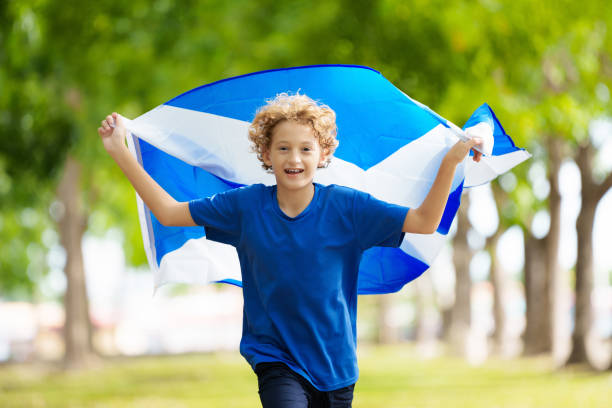 istock Child running with Scotland flag 2156160699