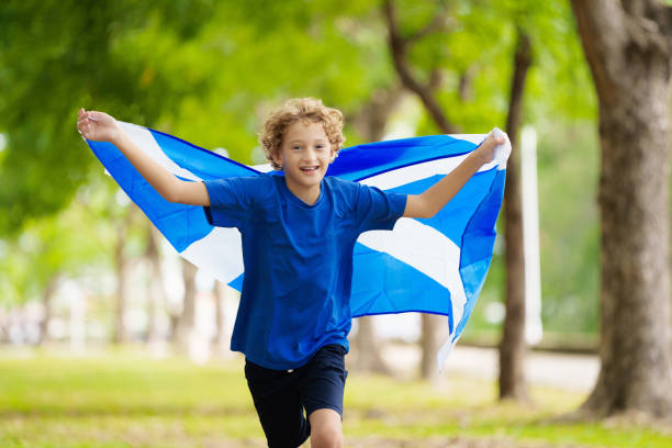 istock Child running with Scotland flag 2156161109