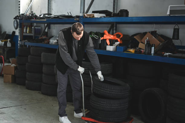 istock Auto mechanic selecting tires in car service centre 2156162587