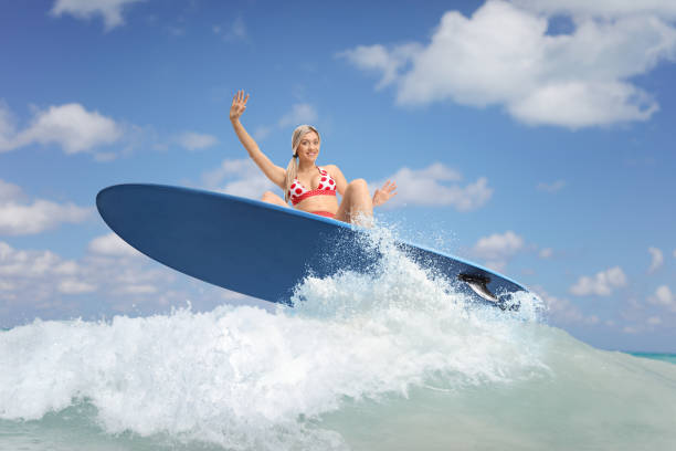 istock Female surfer jumping with a surfboard 2156162602