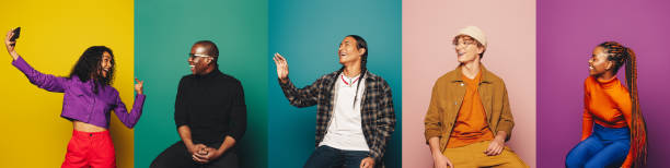 istock Group of young adults posing in colorful studio with vibrant backdrops 2156163261