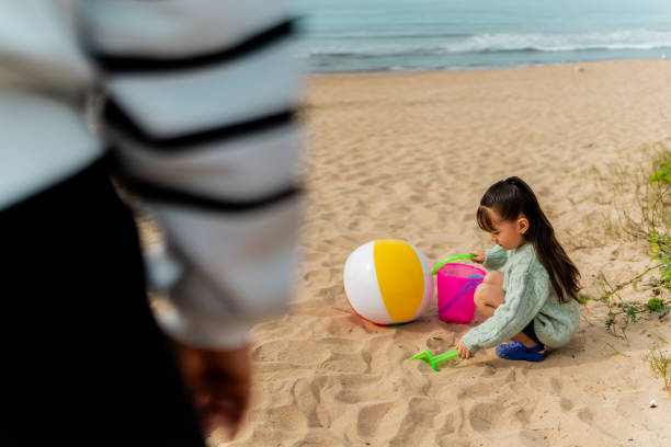Child girl playing sand at beach