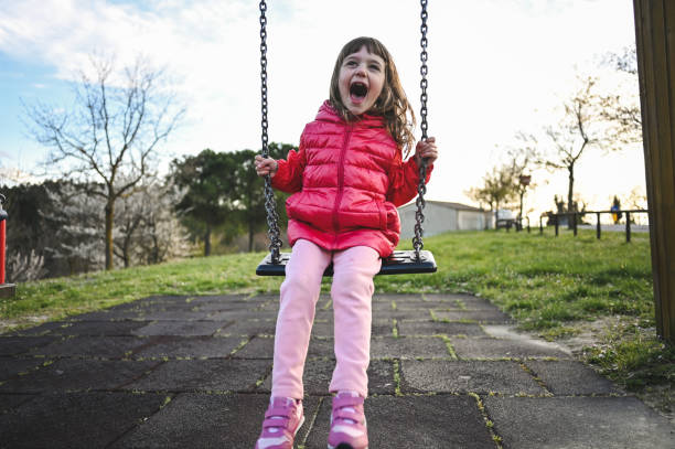 istock Child swinging outdoors. 2156165932