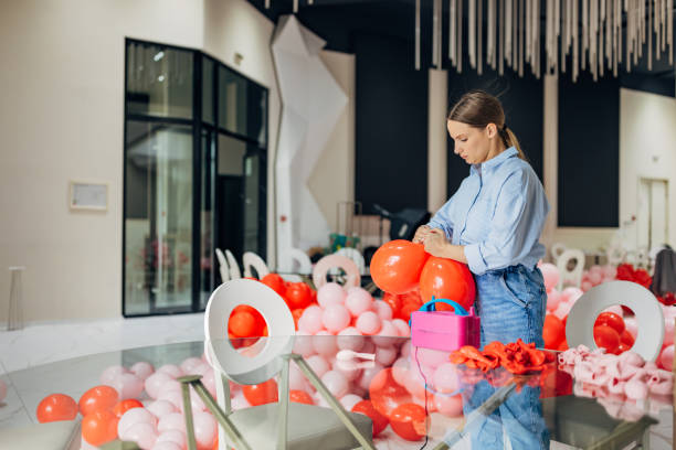 istock The decorator is surrounded by balloons of different colors, while making decorations for the birthday party 2156168268